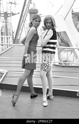 File photo dated 27/01/66 of a 'Dual Control' the name given to the short, slightly flared, summer shift dress in denim by Mary Quant (left), and a black and white 'Mod' dress by Jean Varou, taken aboard the cargo vessel Benarmin in Victoria Dock, London. Fashion designer Mary Quant has died aged 93, her family said. A statement from her family to the PA news agency said she 'died peacefully at home in Surrey, UK this morning'. Issue date: Thursday April 13, 2023. Stock Photo