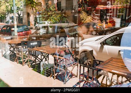 Reflection on the glass of a restaurant window on a street in the city of Buenos Aires, Argentina. copy space. Stock Photo