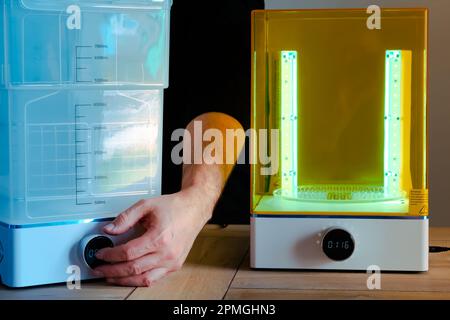 Man adjusting a wash and cure machine using UV light before use, for 3d  resin printer Stock Photo - Alamy