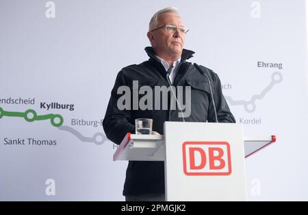 Gerolstein, Germany. 13th Apr, 2023. Achim Hallerbach, Chairman of the Zweckverband Schienenpersonennahverkehr Nord, speaks at Gerolstein station after riding in a premiere railcar on a special trip from Kyllburg to Gerolstein. The premiere trip was the start of train service on the section of the Eifel line between Kyllburg and Gerolstein. From April 17, trains are scheduled to run again on the Eifel line. This means that another section of the badly damaged line will be reconnected to the rail network. Credit: Harald Tittel/dpa/Alamy Live News Stock Photo