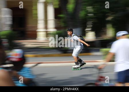 MERIDA, MEXICO - OCTOBER 30, 2016 Sunday cycling on the  Paseo de Montejo - boy on a fast skateboard Stock Photo