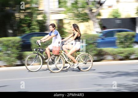 MERIDA, MEXICO - OCTOBER 30, 2016 Sunday cycling on the  Paseo de Montejo - couple talking Stock Photo