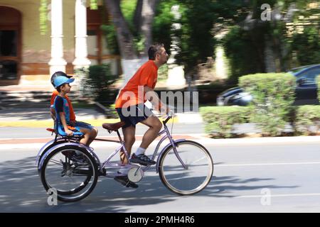 MERIDA, MEXICO - OCTOBER 30, 2016 Sunday cycling on the  Paseo de Montejo - family tricycle Stock Photo