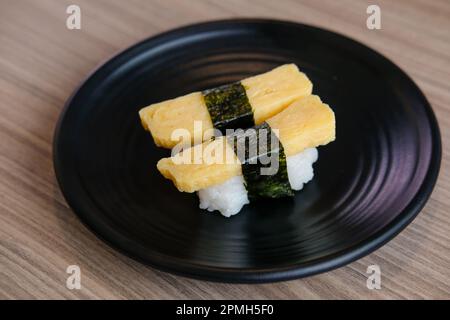 Tamago egg sushi, egg omelet on sushi rice. served on plate Stock Photo