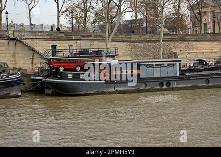 PARIS, FRANCE - DECEMBER 2, 2017  a barge moored on the banks of the River Seine Stock Photo