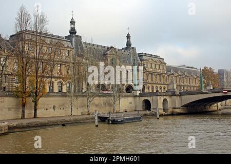 PARIS, FRANCE - DECEMBER 2, 2017  buildings on the banks of the River Seine on a grey overcast day Stock Photo