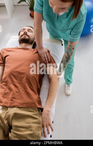 Masseuse Doing Seated Shoulder Massage For Businessman Stock Photo, Picture  and Royalty Free Image. Image 114325390.