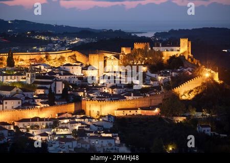 View over the old town and walls of Obidos floodlit at night, Obidos, Centro Region, Estremadura, Portugal, Europe Stock Photo