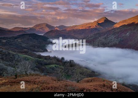 First Light on Yr Aran and a fog filled Nant Gwynant Valley, Nant Gwynant, Eryri, Snowdonia National Park, North Wales, United Kingdom, Europe Stock Photo