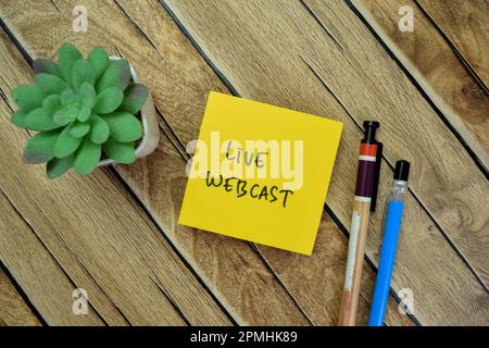 Concept of Live Webcast write on sticky notes isolated on Wooden Table. Stock Photo