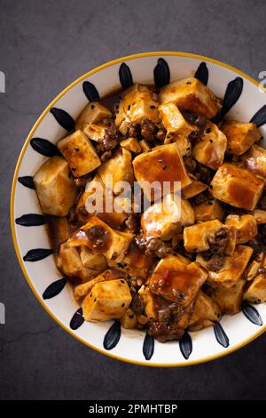 A close-up of a bowl of steaming hot, freshly cooked Mapo tofu Stock Photo