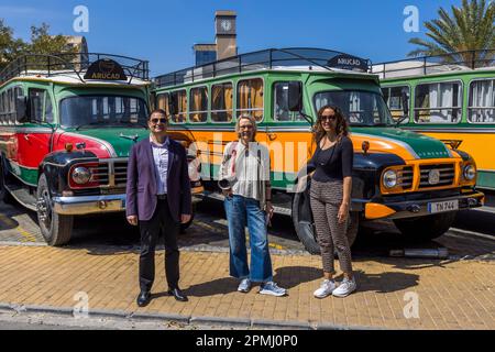 Vice-Chancellor Prof. Dr Asım Vehbi (left) poses with journalist Angela Berg (centre) and Nelin Tunc (right) in front of three restored vintage buses bearing the ARUCAD logo on the campus of Arkin University of Creative Arts and Design in Kyrenia (Girne in Turkish), Turkish Republic of Northern Cyprus (TRNC). Founded in 2017 by the Arkın Group, the university is a specialised institution dedicated exclusively to art, design and communication. Stock Photo