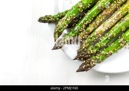 Glazed green asparagus with sesame seeds Stock Photo