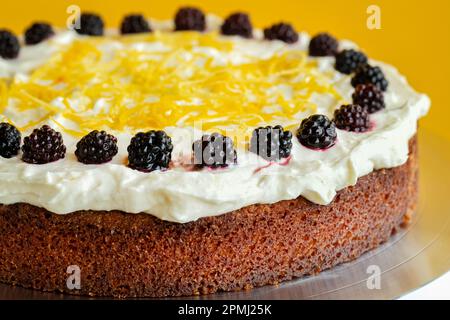 A Blackcurrant, Lemon Polenta cake. The cake is made with Italian Polenta, a corn flour or corn meal and has cream cheese topping and is gluten free Stock Photo