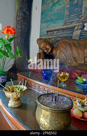 Reclining Buddha statue on an altar in a prayer room of the Brahma Vihara Buddhist monastery, Banjar, North Bali, Bali, Indonesia Stock Photo