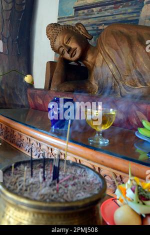 Reclining Buddha statue on an altar in a prayer room of the Brahma Vihara Buddhist monastery, Banjar, North Bali, Bali, Indonesia Stock Photo