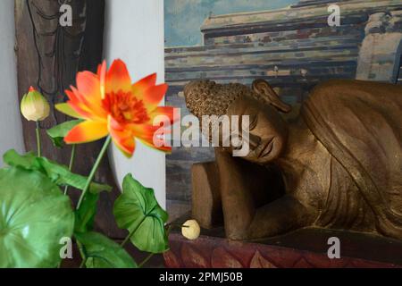 Reclining Buddha statue on an altar in a prayer room of the Brahma Vihara Buddhist monastery, Banjar, North Bali, Bali, Indonesia Stock Photo