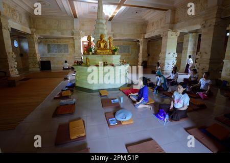 Believers meditate in prayer room, Brahma Vihara Buddhist monastery, Banjar, North Bali, Bali, Indonesia Stock Photo