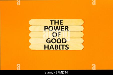 The power of good habits symbol. Concept words The power of good habits on wooden stick. Beautiful orange table orange background. Business the power Stock Photo