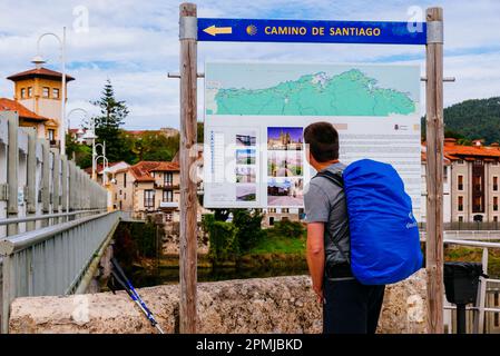 Pilgrim looking at the map. The Northern Way, also called the Coastal Way, is one of the routes of the Camino de Santiago, Way of Saint James. Bridge Stock Photo