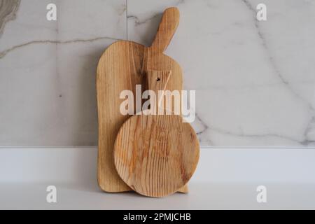 Wooden chopping boards on kitchen countertops. Set of wood cutting boards in different sizes. Stock Photo