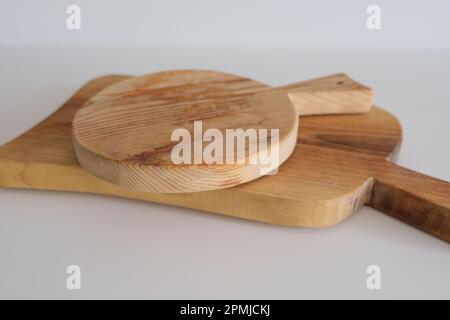 Wooden chopping boards on kitchen countertops. Set of wood cutting boards in different sizes. Stock Photo