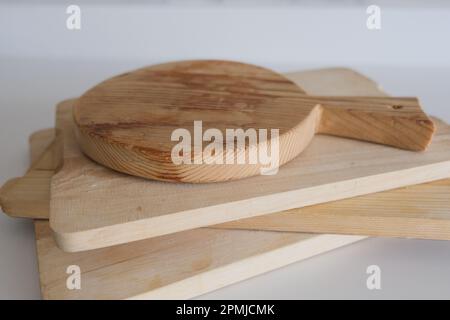 Wooden chopping boards on kitchen countertops. Set of wood cutting boards in different sizes. Stock Photo
