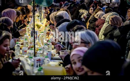 ROTTERDAM - 13/04/2023, Visitors during the annual iftar on the street in front of the Markthal. During the iftar, Muslims eat the evening meal after sunset during the fasting month of Ramadan. ANP ROBIN UTRECHT netherlands out - belgium out Stock Photo