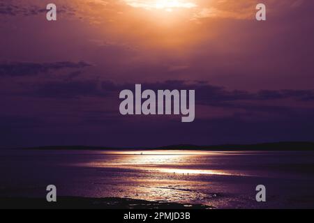 Beautiful scenery of purple sunset on the sea Stock Photo