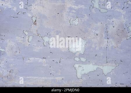 Detail of worn out mauve paint on a closed store window, grunge texture, abstract background Stock Photo