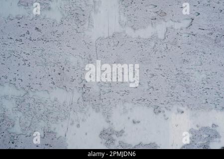 Detail of worn out plaster coating on a closed store window, grunge texture, abstract background Stock Photo
