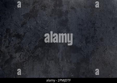 Old worn out black plastered wall texture, grunge background Stock Photo