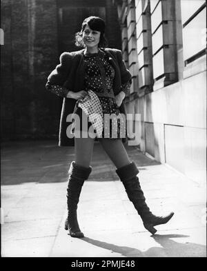 Apr. 04, 1971 London, England, UK: Mary Quant Fashions.: Mary Quant's Ginger Group and Knitwear Collections for Autumn and Winter, were shown in London today. Photo shows Model Anne Goddet wearing ''Hopscotch'' - Cabled velvet leotard with liberty check top and matching skirt and orange fake fur jacket. (Credit Image: © Keystone Press Agency/ZUMA Press Wire) EDITORIAL USAGE ONLY! Not for Commercial USAGE! Stock Photo