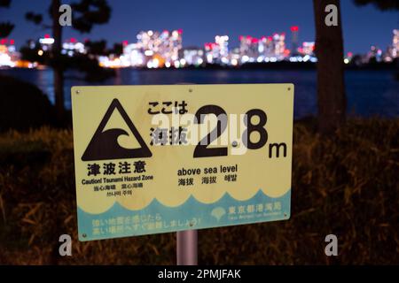 Tokyo, Japan. 9th Feb, 2023. A Tsunami elevation warning sign. Disaster preparedness, earthquakes.Odaiba Marine Park (ãŠå°å ´æµ·æµœå…¬åœ') is a public park in Tokyo, Japan. It is located on the artificial island of Odaiba in Tokyo Bay. The park has a beach, a promenade, and a variety of attractions, including a replica of the Statue of Liberty.The Japanese economy is the third largest in the world, after the United States and China. It is a highly developed market economy with a strong manufacturing sector. The Japanese economy is also heavily reliant on exports, and it has been strug Stock Photo