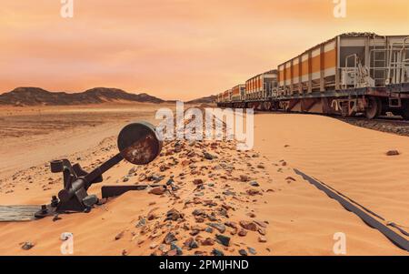 Old unused train at Wadi Rum train station, railroad switch foreground, sandy desert around Stock Photo