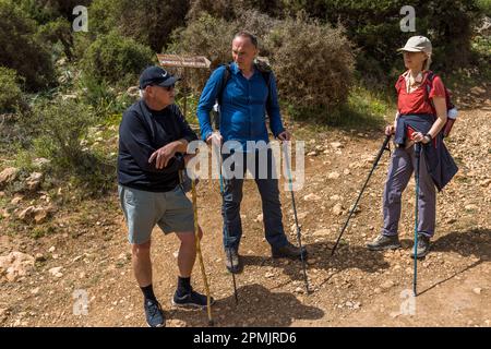 Hiking guide Franz Bauernhofer (m.) during a guided hike on the Aphrodite Trail on Akamis peninsula in Cyprus Stock Photo
