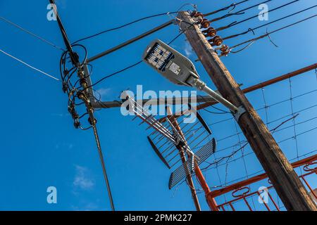 Cable, antenna and lamp clutter; but at least with LED lights in Omodos, Cyprus Stock Photo