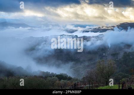 Landscape of the village of Sabroso on the outskirts of Vila Real in Portugal, shrouded in clouds and mist after heavy rain, on a stormy day. Stock Photo