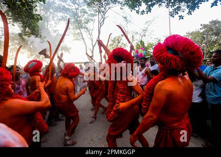 Bangladesh, 13/04/2023, As the month of Chaitra, the last in the Bangla year draws to an end, the Hindu community comes together in a festival dedicated to the worship of Lord Shiva and Parvati. The program is locally known as “Lal Kach” (red glass). The central idea behind this program is for a group of soldiers led by Shiva to appear on earth with a mission: ward off the forces of evil. These soldiers, glowing in the divine light of Shiva, march toward nearby temples. It is all part of a very long tradition going back hundreds of years. The Hindus, especially the young, paint themselves in r Stock Photo