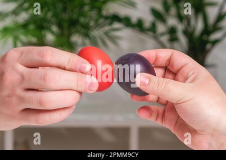 Two people are beating Easter eggs. A tradition for Easter. Stock Photo