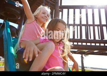 Theres no friend like a sister. little girls playing on a jungle gym. Stock Photo