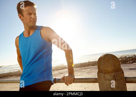 That feeling after an amazing workout...a man taking a break after a long jog. Stock Photo