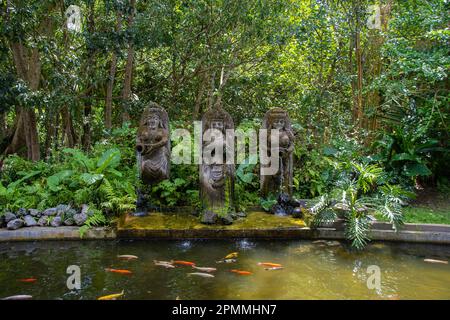 Koi pond with Balinese stone sculptures in Monkey Forest in Ubud Stock Photo