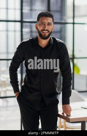 Portrait of successful businessman standing in office Stock Photo