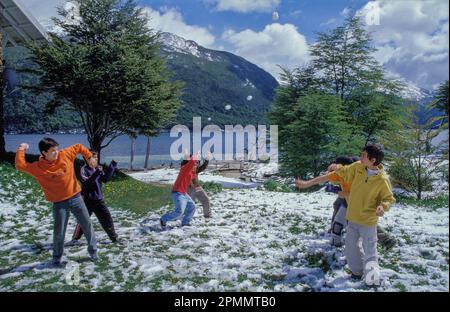 Argentina, Tierra del Fuego. Children having fun in the snow. Stock Photo