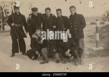 Rome, Italy may 1951: Group of Italian military personnel enjoying their leisure time on a beach, representing the human side of armed forces in the 1 Stock Photo
