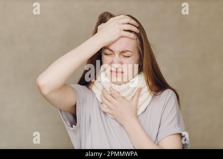 Young woman wearing scarf flu catarrh ill sick disease treatment cold Stock Photo