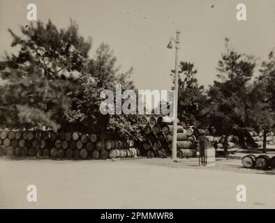 Rome, Italy may 1951: A pile of barrels sitting in a large open yard, used for storage, shipping, and industrial purposes. Stock Photo