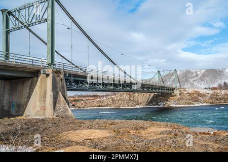 Iceland's iconic Ölfusárbrú bridge a 2-lane, 84m vehicular steel wire suspension bridge over Ölfusá river connecting Ring Road One with Selfoss Town. Stock Photo