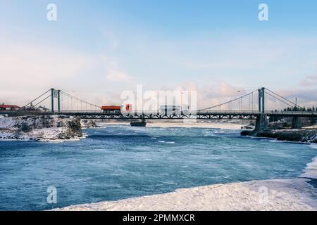 Iceland's iconic Ölfusárbrú bridge a 2-lane, 84m vehicular steel wire suspension bridge over Ölfusá river connecting Ring Road One with Selfoss Town. Stock Photo